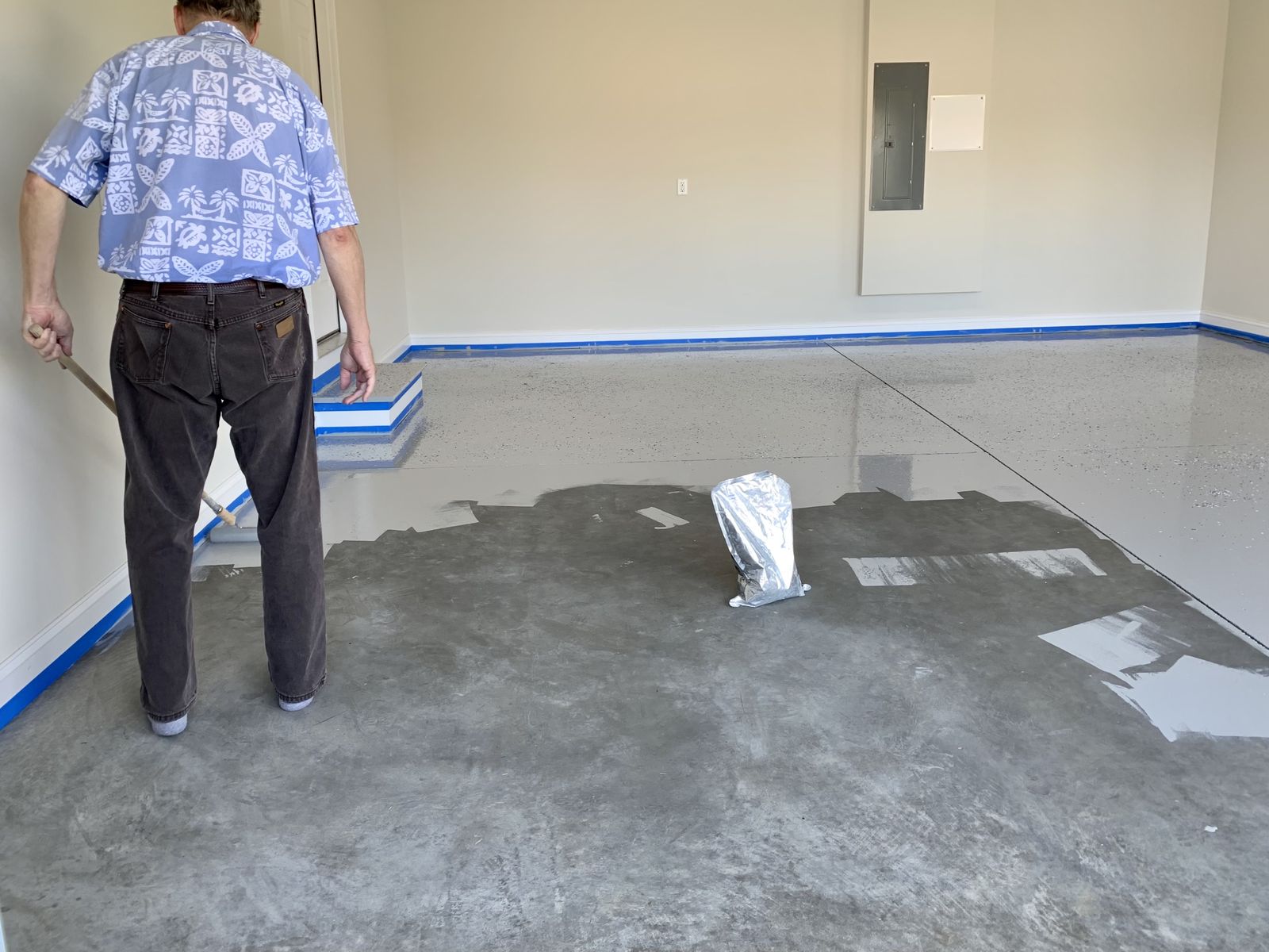 Polyurea base coat being applied in a garage