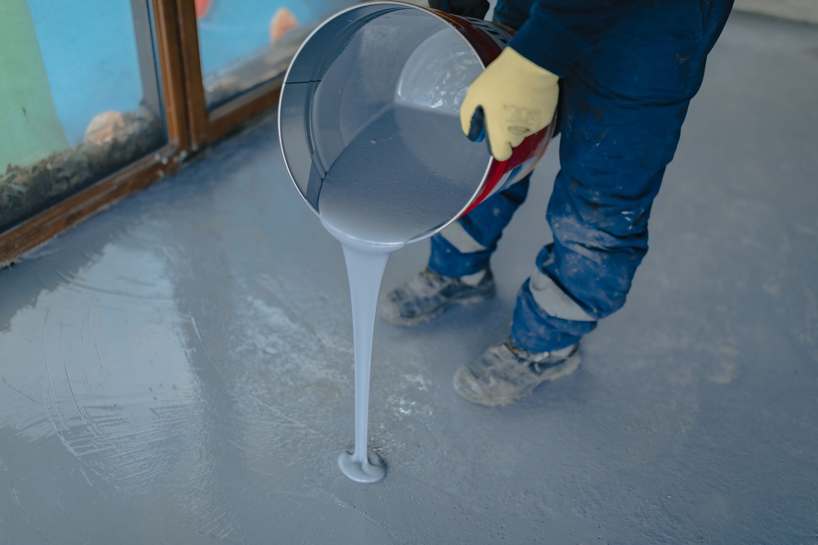 Grey floor coating being poured